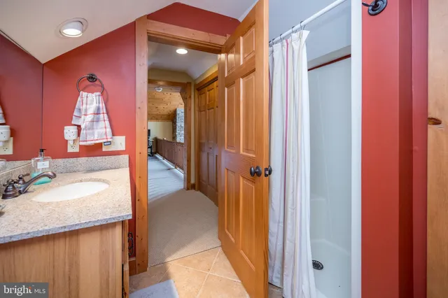 a bathroom with a granite countertop sink a toilet and mirror