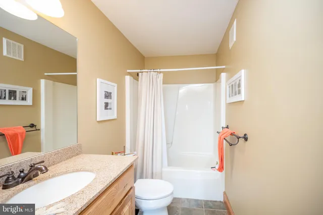 a bedroom with a bed and glass door