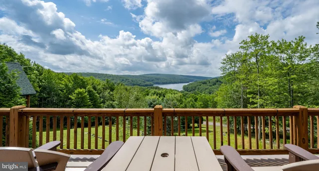 a view of balcony with wooden floor and fence
