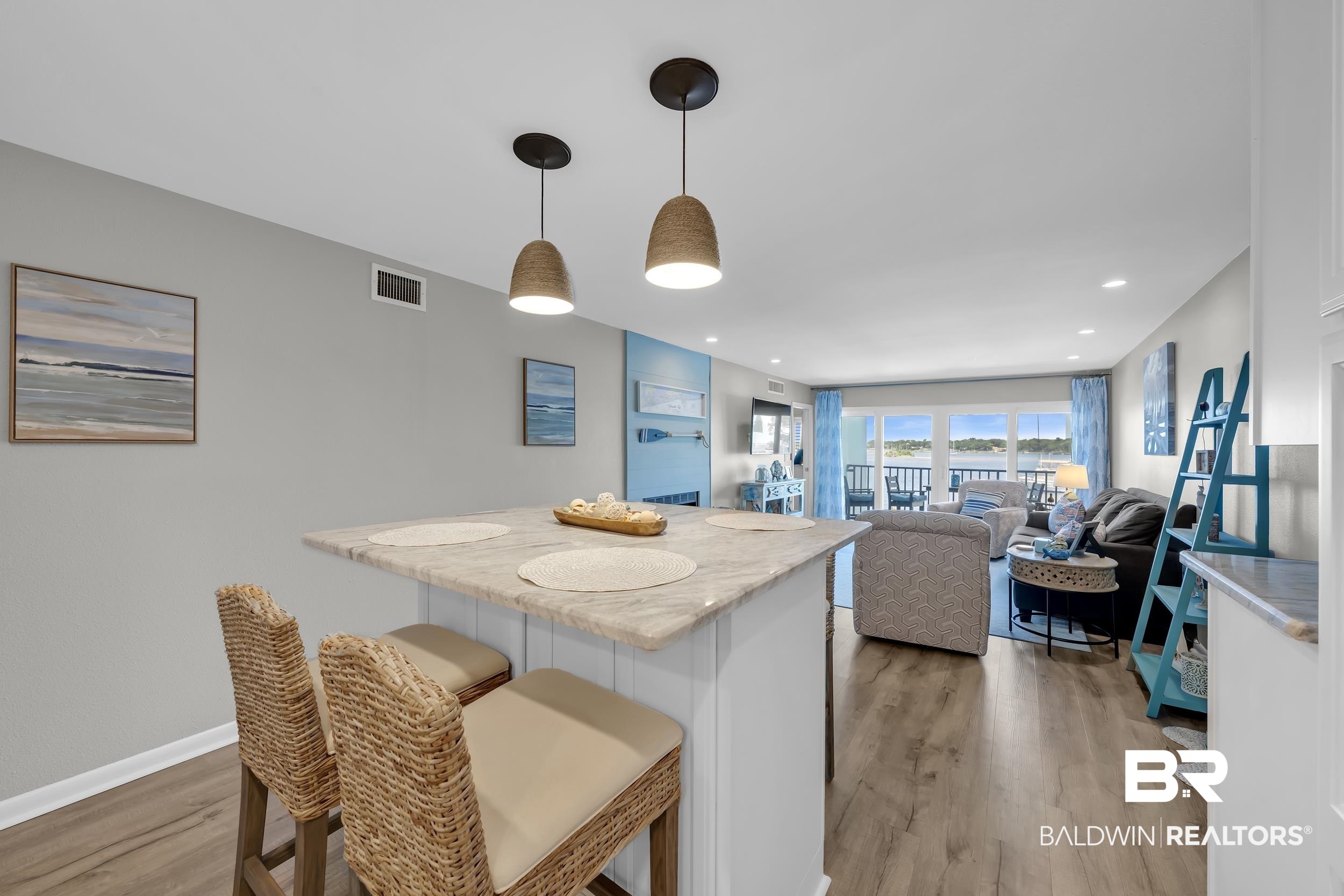 14100 River Road, Unit 211 Pensacola, FL 32507 - Photo 18 of 56 Kitchen island featuring a light-colored countertop and white paneled base