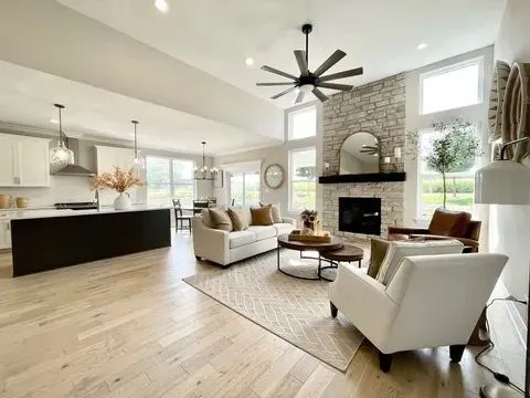 a kitchen with stainless steel appliances granite countertop a sink a stove and a wooden floors