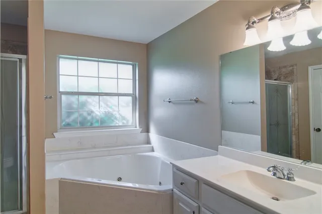 a bathroom with a bathtub and a sink