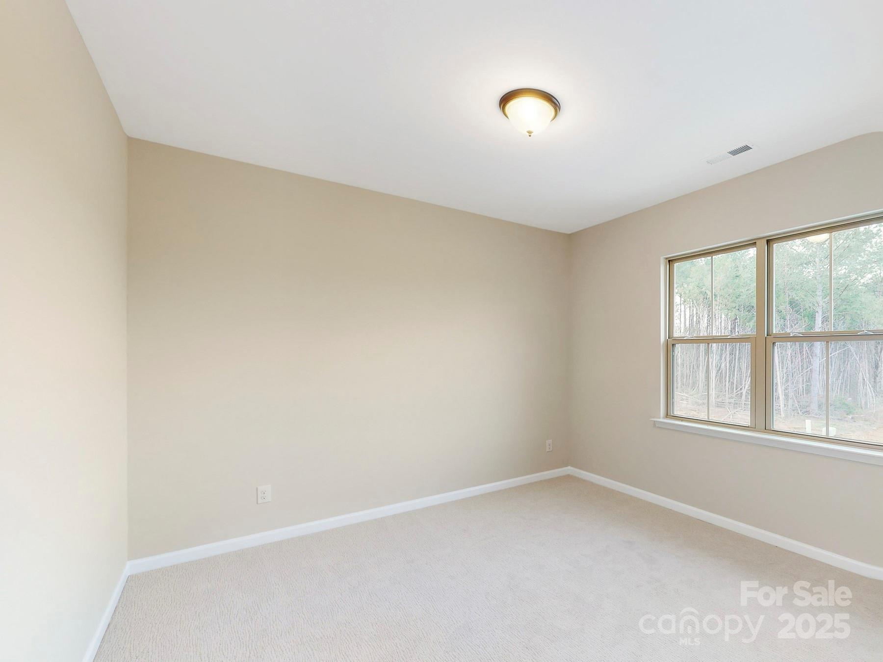 7089 Cobblefield Lane Denver, NC 28037 - Photo 27 of 36 an empty room with a empty space and windows