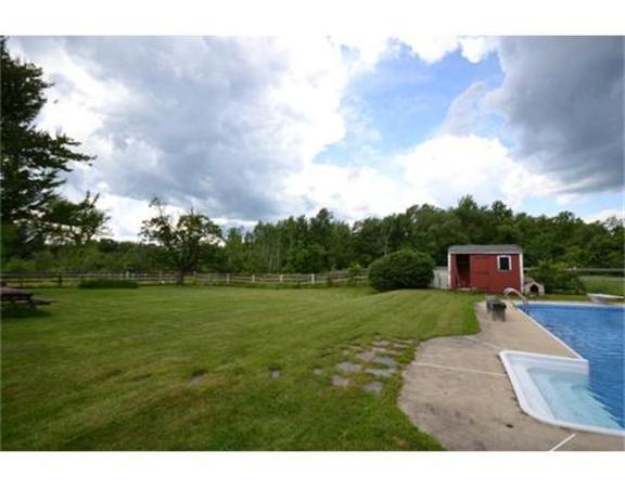644 Northfield Road Lunenburg, MA 01462 - Photo 6 of 13 a backyard of a house with table and chairs