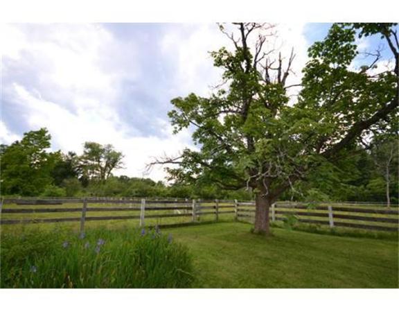 644 Northfield Road Lunenburg, MA 01462 - Photo 9 of 13 a grassy field with trees in the background