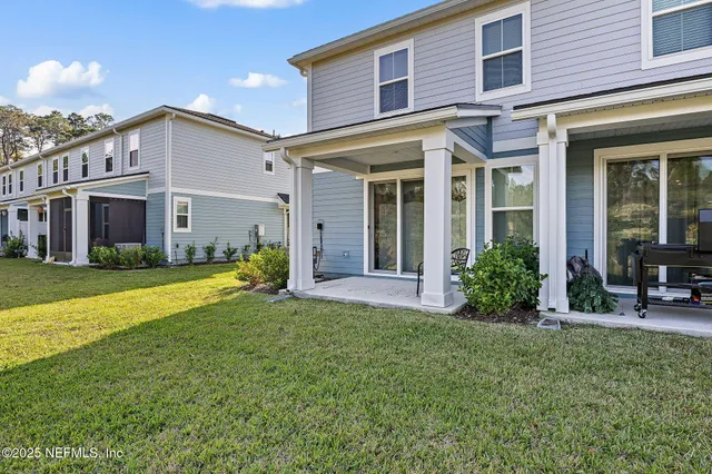 a view of a house with a yard and sitting area