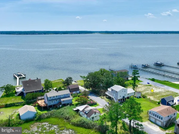 an aerial view of a house with garden space and street view