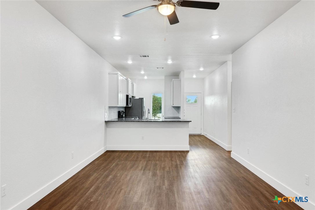 1920 Royal Loop Belton, TX 76513 - Photo 6 of 15 a large kitchen with a wooden floor and stainless steel appliances