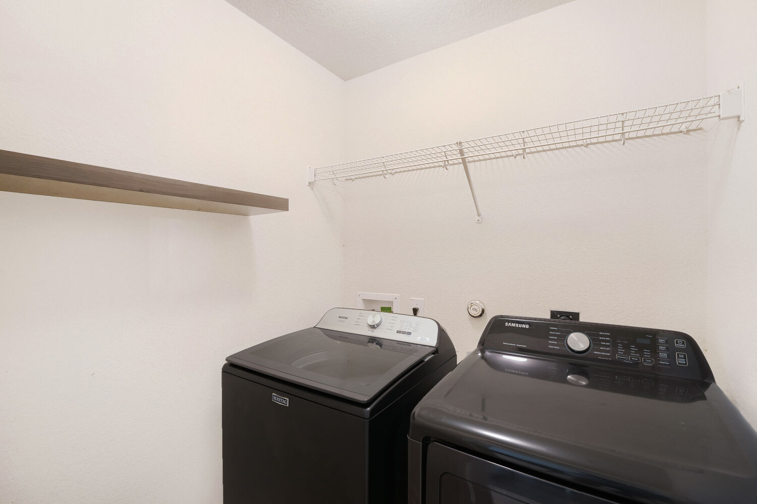 116 Millers Loop Jarrell, TX 76537 - Photo 19 of 23 Functional laundry space featuring modern appliances and convenient shelving for organization.