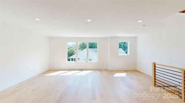 a view of kitchen with sink and refrigerator