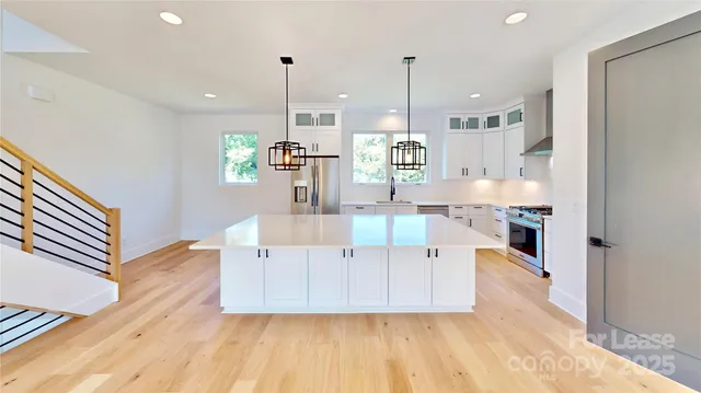 a view of a kitchen with a sink and chandelier