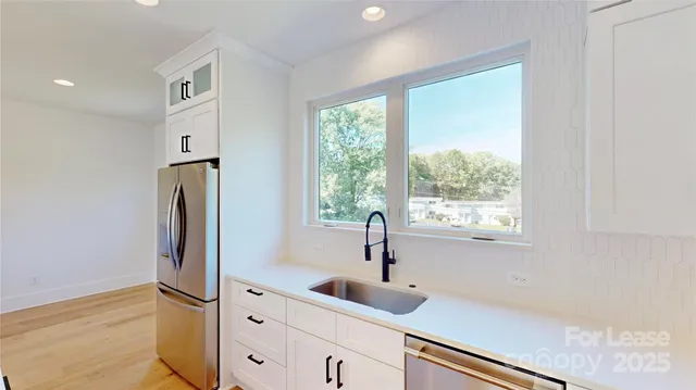 a view of a kitchen with a large window and kitchen view