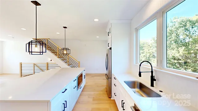 a kitchen with granite countertop a sink and a window