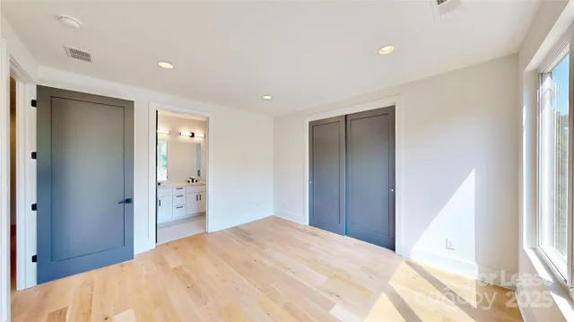 a bathroom with a sink vanity mirror and toilet