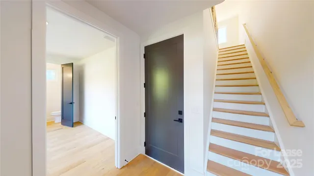 a large white kitchen with a large window