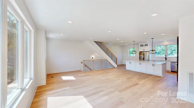 a view of a kitchen with furniture and wooden floor