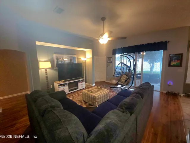 a living room with furniture a rug and a chandelier