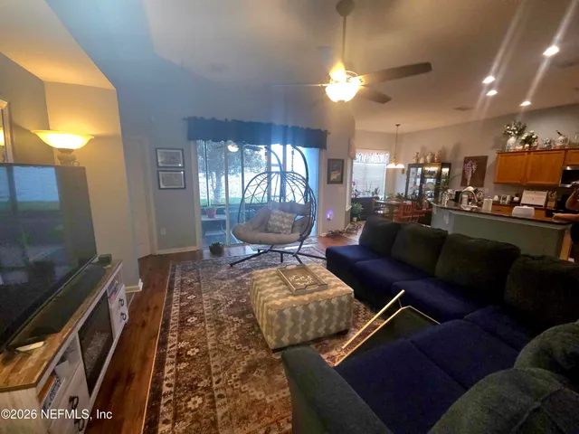 a living room with furniture and a flat screen tv