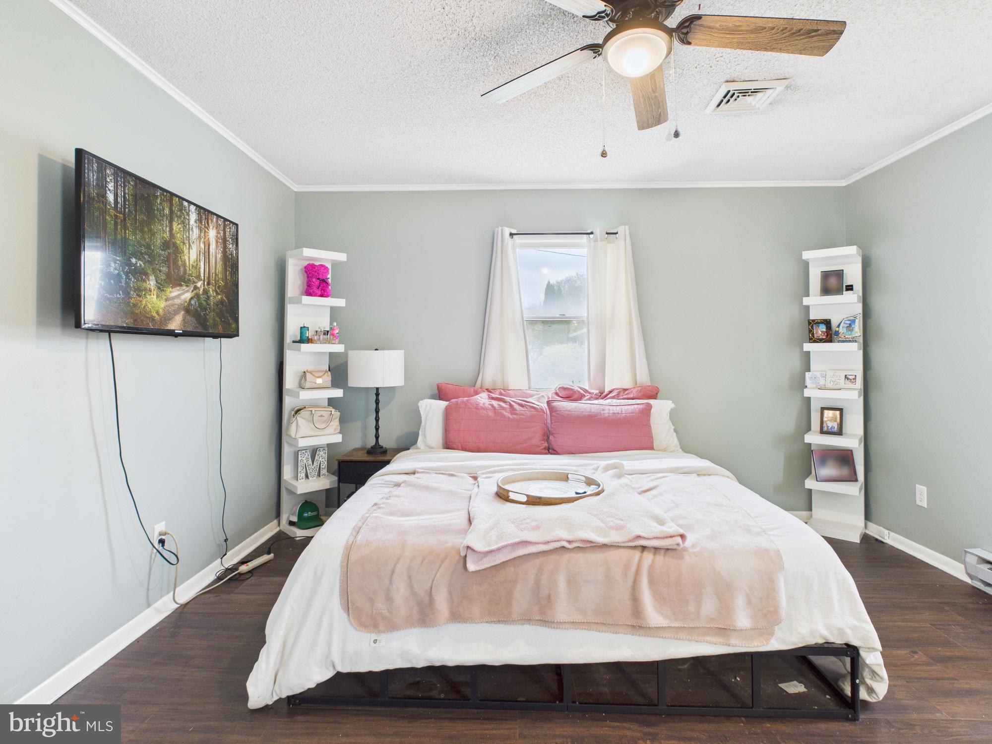 38 South Carter Road Smyrna, DE 19977 - Photo 21 of 30 a bedroom with a bed and a chandelier