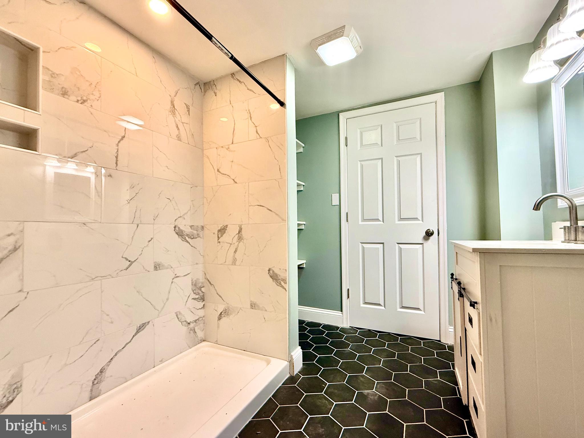 38 South Carter Road Smyrna, DE 19977 - Photo 3 of 30 a bathroom with a bathtub and a shower