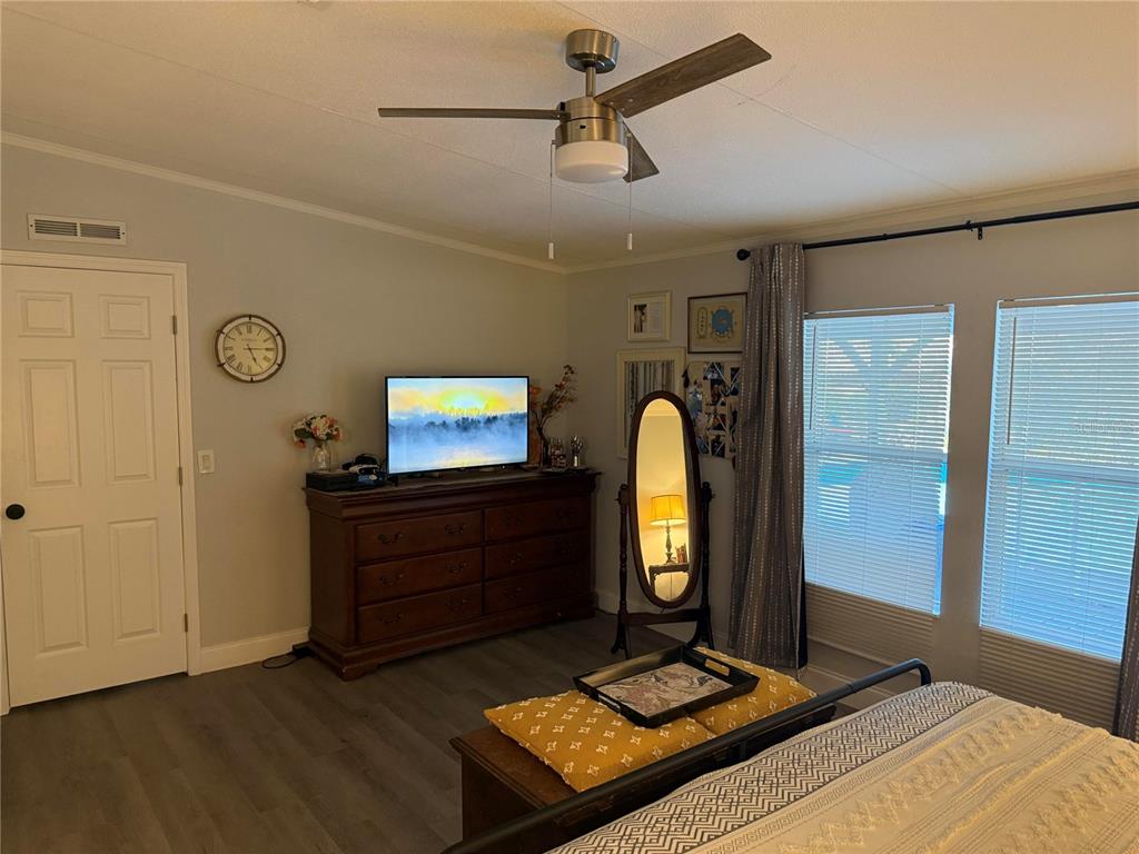 900 Racoon Trail Frostproof, FL 33843 - Photo 15 of 25 a bedroom with a bed and a mirror