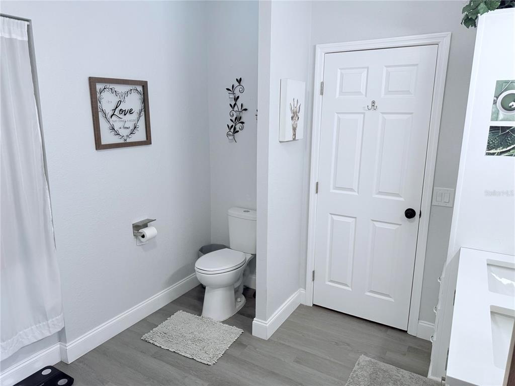 900 Racoon Trail Frostproof, FL 33843 - Photo 18 of 25 a bathroom with a toilet and a shower