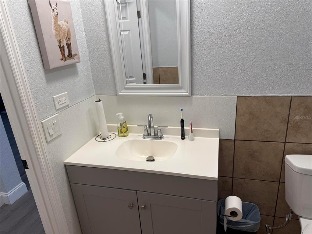 900 Racoon Trail Frostproof, FL 33843 - Photo 22 of 25 a bathroom with a sink and a mirror