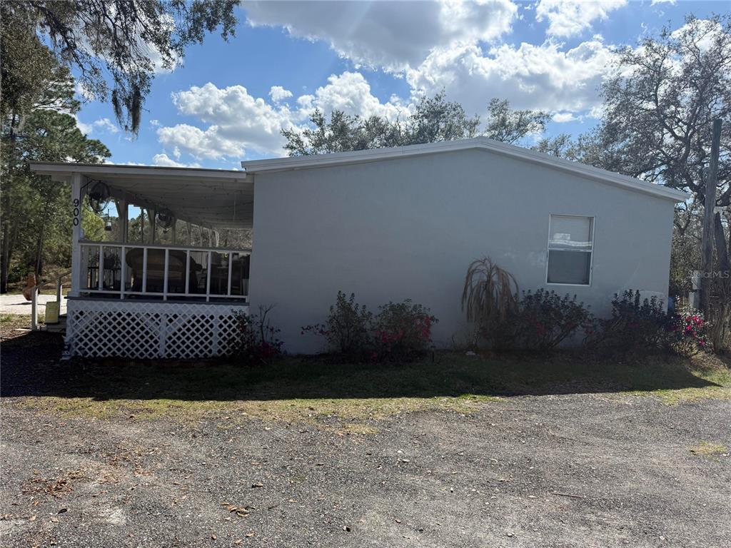 900 Racoon Trail Frostproof, FL 33843 - Photo 25 of 25 a view of a porch with a garden