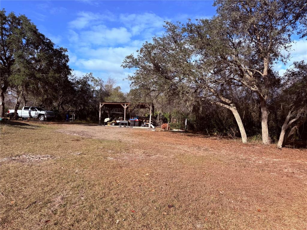 900 Racoon Trail Frostproof, FL 33843 - Photo 5 of 25 a view of outdoor space with trees