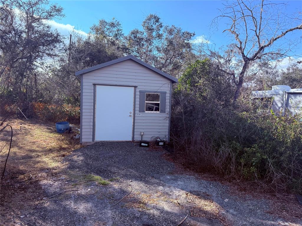 900 Racoon Trail Frostproof, FL 33843 - Photo 7 of 25 a view of a house with a yard