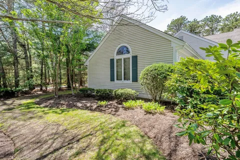 a view of a house with backyard and sitting area