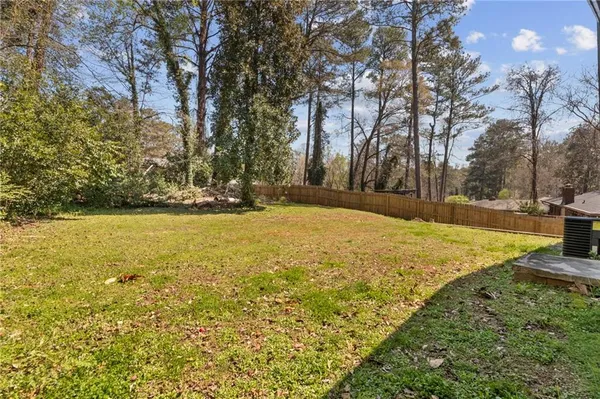 a view of yard with swimming pool and trees