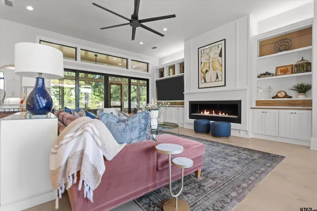 a living room with furniture a fireplace and a flat screen tv