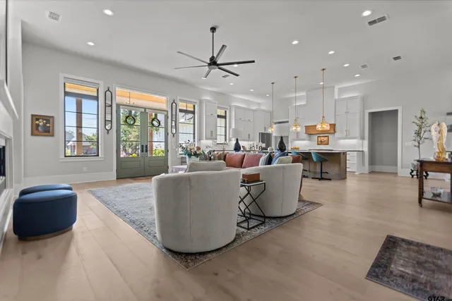 a living room with furniture and a chandelier