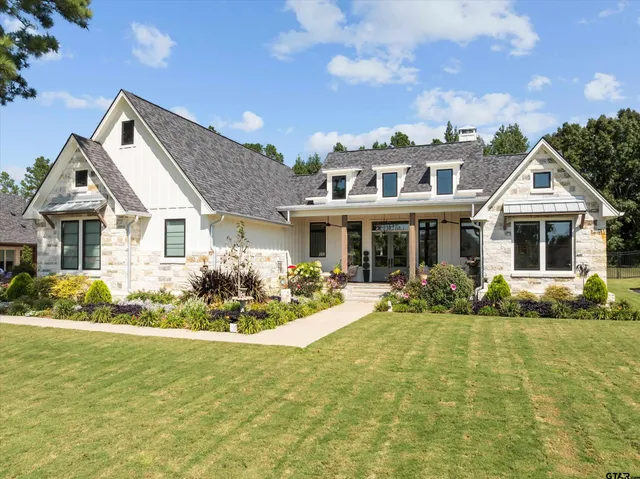 a front view of house with yard outdoor seating and green space
