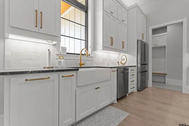 a kitchen with stainless steel appliances granite countertop a refrigerator sink and cabinets