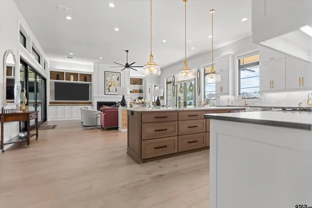 a large kitchen with a large counter top appliances and cabinets