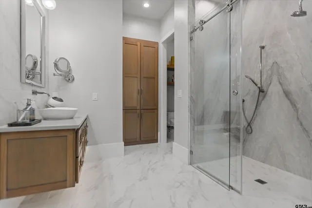 a bathroom with a shower and a sink