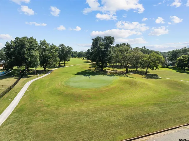 a swimming pool with trees in the background