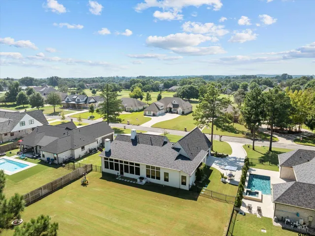 a aerial view of a house with swimming pool and mountain view