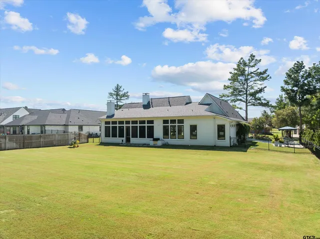 a view of a house with swimming pool and deck