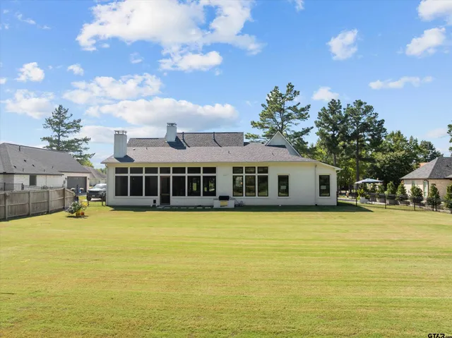 a view of a house with swimming pool and a yard