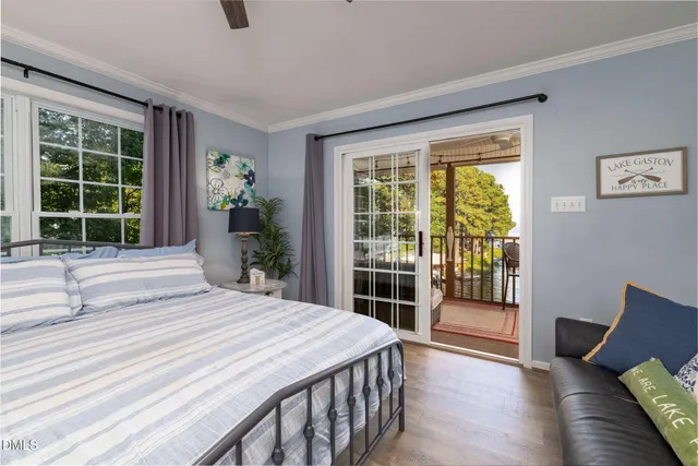 a kitchen with stainless steel appliances granite countertop a stove top oven a sink dishwasher a dining table and chairs with wooden floor