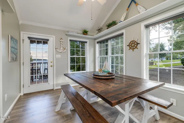 a roof deck with couches and wooden floor