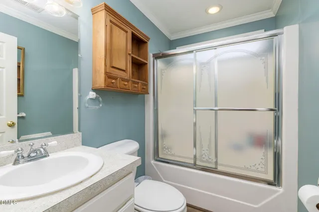 a bathroom with a sink a mirror a toilet and shower