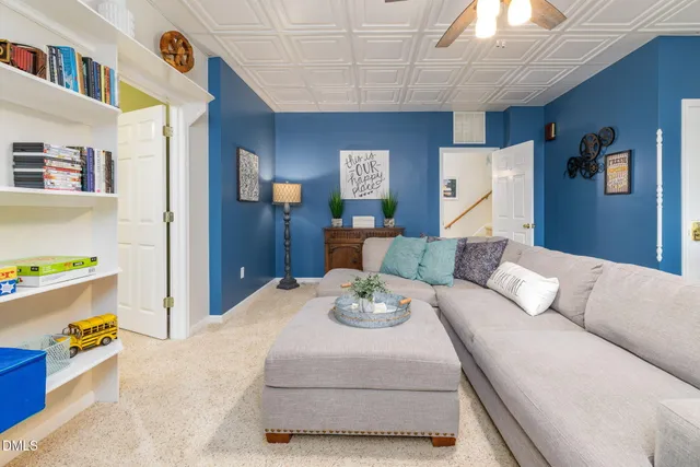 a view of a house with large tree and wooden fence