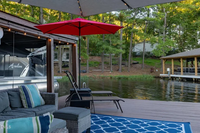 a backyard of a house with table and chairs plants and large trees