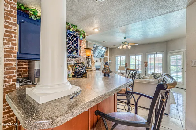 a living room with furniture a flat screen tv and a floor to ceiling window