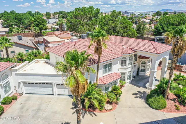 an aerial view of a house with a yard and outdoor seating