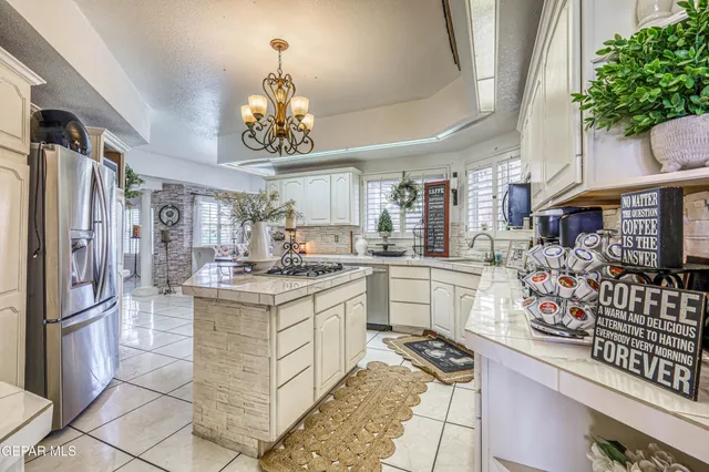 a view of a dining room with furniture a chandelier and wooden floor